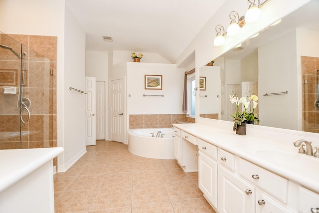 bathroom featuring visible vents, a bath, a shower stall, vaulted ceiling, and tile patterned floors