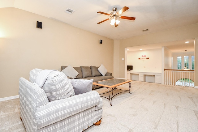 carpeted living room with baseboards, a ceiling fan, visible vents, and lofted ceiling
