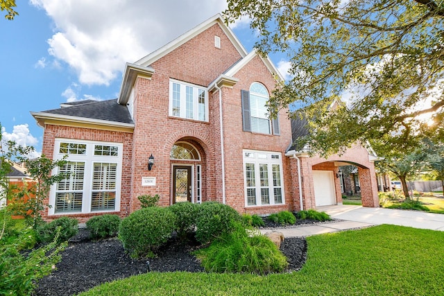 view of property featuring a front lawn and a garage