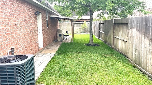 view of yard with a fenced backyard and cooling unit