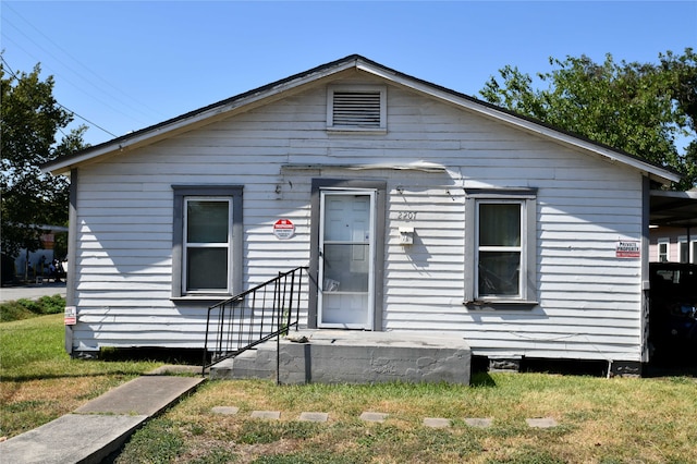 bungalow with a front yard