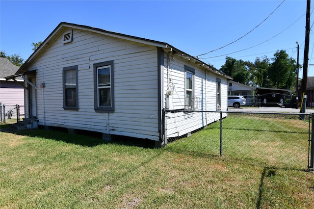 view of side of property with a lawn