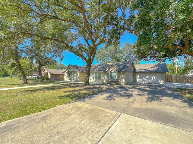 ranch-style home with a garage and a front lawn