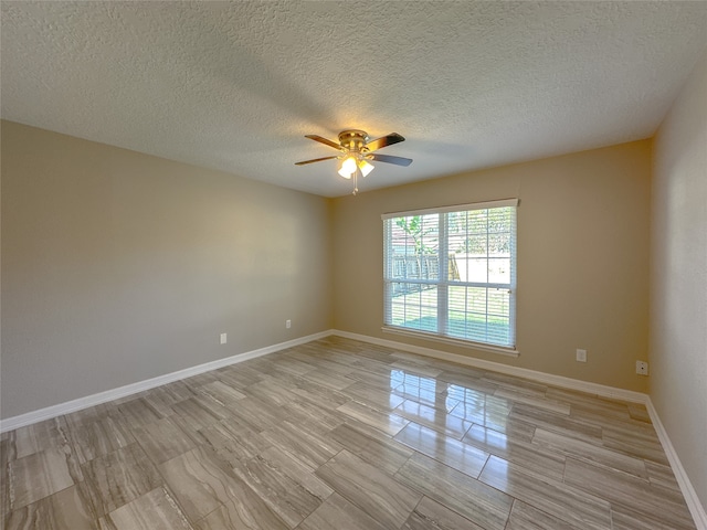 empty room featuring ceiling fan, a textured ceiling, and light hardwood / wood-style floors