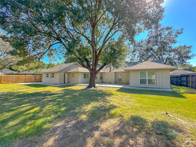 back of property featuring a yard and a patio