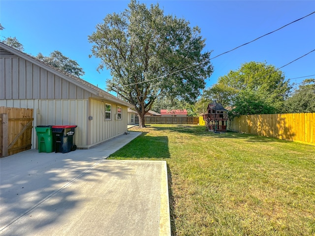 view of yard with a playground and a patio