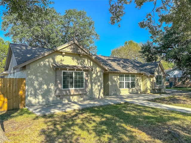 view of front facade with a front lawn and a patio