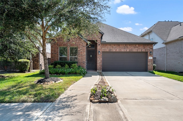 view of front of house featuring a front yard and a garage