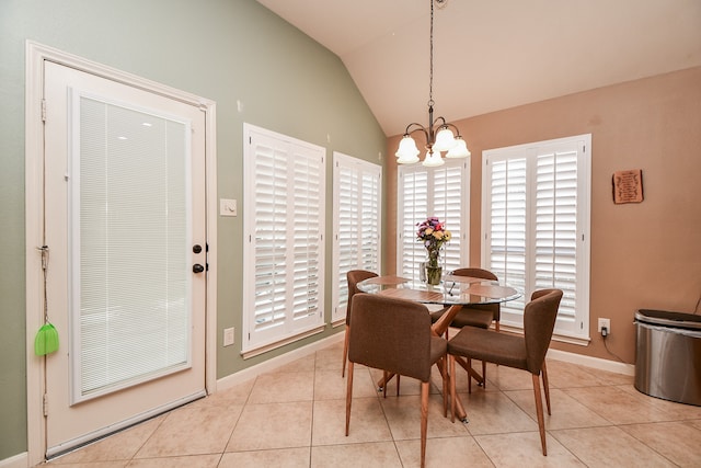 dining room featuring light tile patterned floors, a notable chandelier, and vaulted ceiling