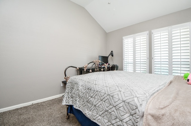 bedroom with carpet floors and vaulted ceiling