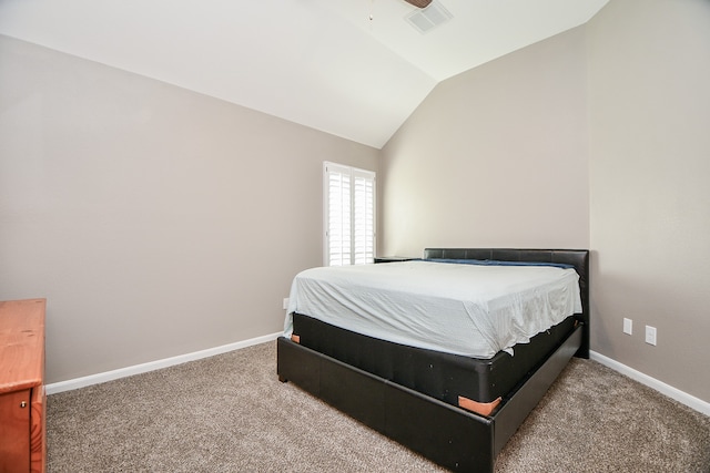 bedroom with ceiling fan, lofted ceiling, and carpet flooring