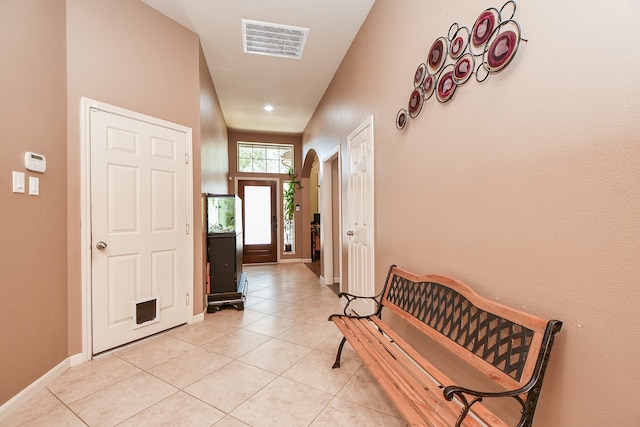 doorway featuring light tile patterned flooring