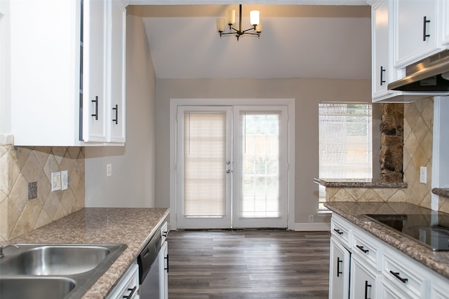 kitchen with black electric cooktop, white cabinets, dark hardwood / wood-style floors, and decorative backsplash