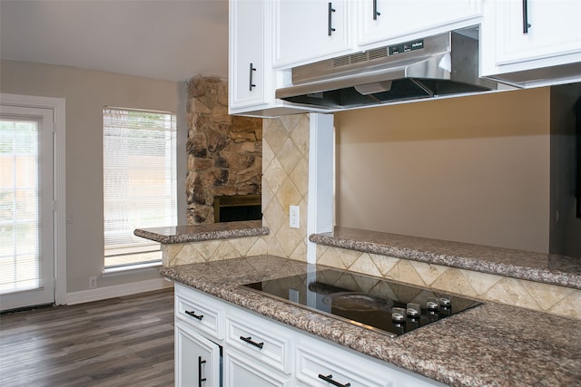 kitchen featuring black electric cooktop, white cabinetry, backsplash, and dark hardwood / wood-style flooring