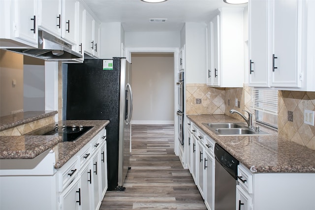 kitchen featuring stainless steel appliances, sink, light wood-type flooring, and white cabinetry