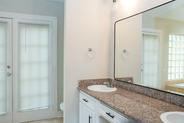 bathroom featuring tile patterned floors, vanity, and toilet