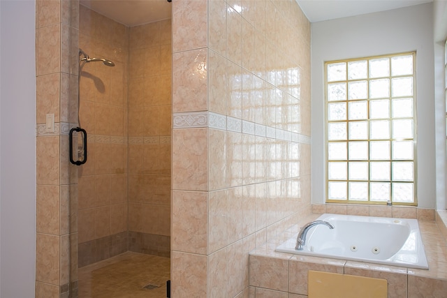 bathroom featuring independent shower and bath and plenty of natural light