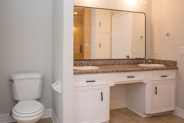 bathroom featuring walk in shower, vanity, tile patterned flooring, and toilet