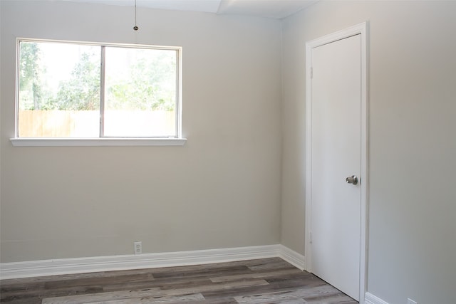 spare room featuring dark wood-type flooring