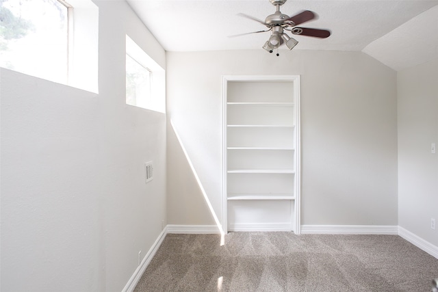 spacious closet with carpet floors, lofted ceiling, and ceiling fan