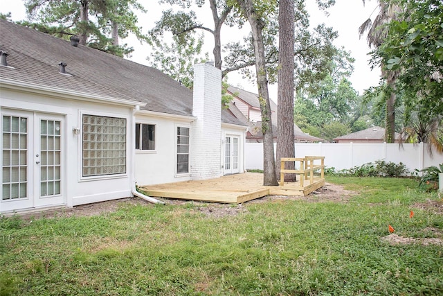 view of yard with french doors and a wooden deck