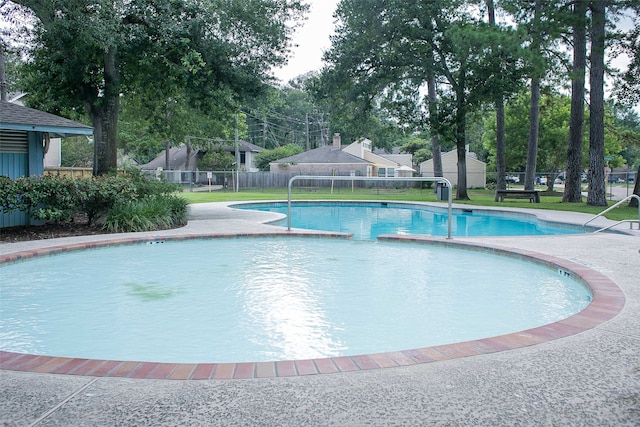 view of pool featuring a lawn