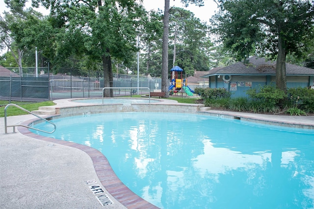 view of pool with a playground