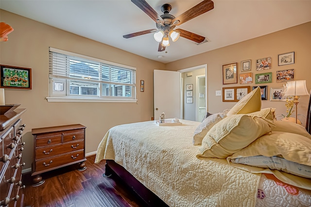 bedroom with dark hardwood / wood-style flooring and ceiling fan