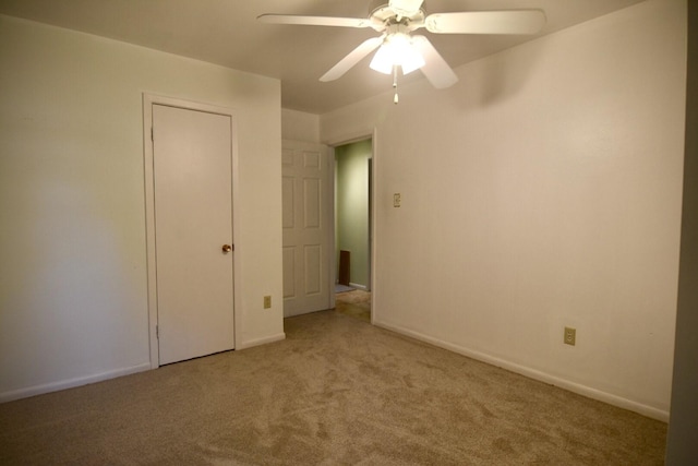 unfurnished bedroom featuring carpet and ceiling fan