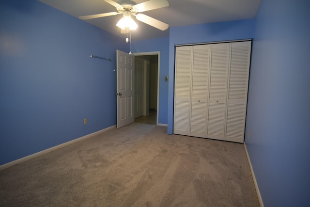 unfurnished bedroom with a closet, ceiling fan, and light colored carpet