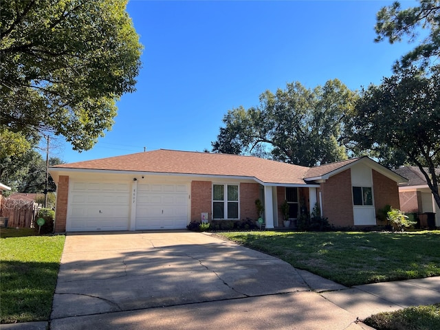 single story home with a front yard and a garage