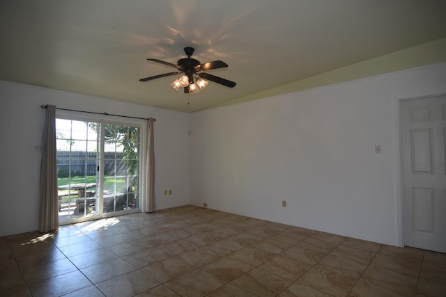 empty room featuring ceiling fan, light tile patterned floors, and lofted ceiling