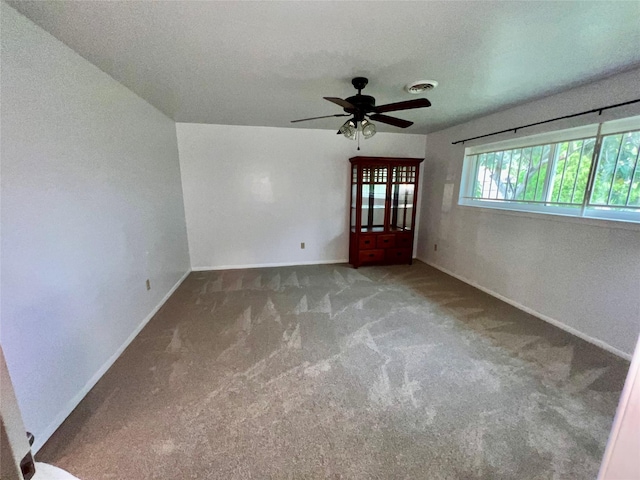 unfurnished room featuring ceiling fan, carpet, and a textured ceiling