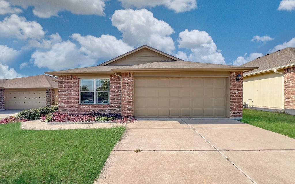 single story home featuring a front yard and a garage