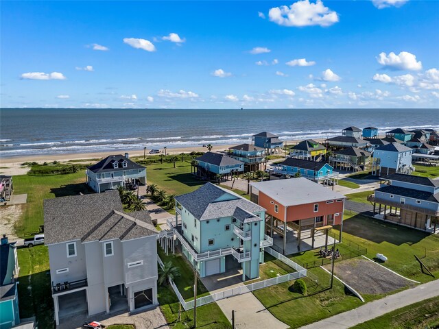 bird's eye view with a water view and a beach view