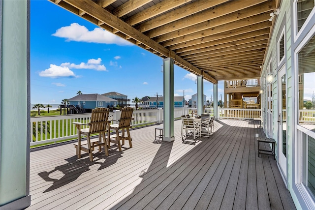 deck with a residential view and outdoor dining area