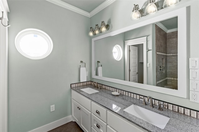 bathroom with vanity, a healthy amount of sunlight, ornamental molding, and tiled shower