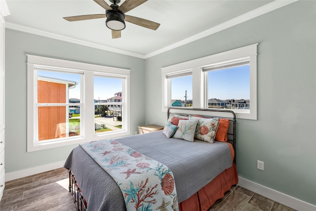 bedroom featuring ornamental molding, hardwood / wood-style floors, and ceiling fan