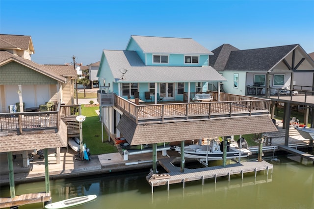 rear view of property with a deck with water view