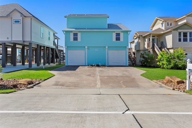 view of front of home with a front yard and a garage