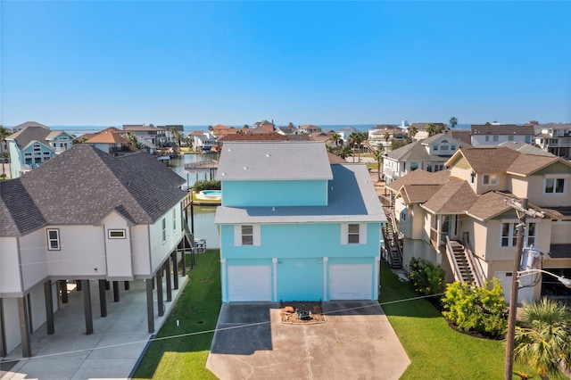 drone / aerial view with a residential view and a water view