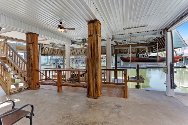 exterior space featuring a water view, ceiling fan, and a dock