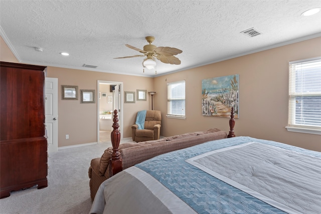 carpeted bedroom featuring ceiling fan, crown molding, a textured ceiling, and ensuite bathroom