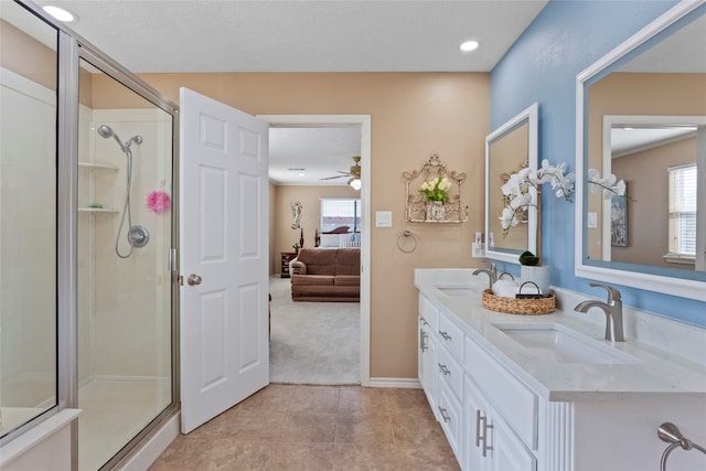 bathroom featuring vanity, an enclosed shower, tile patterned floors, and ceiling fan