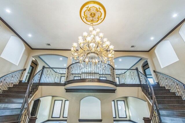 24578 Derry St, Hempstead, TX 77445 - stairs featuring arched walkways, a towering ceiling, crown molding, a chandelier, and recessed lighting