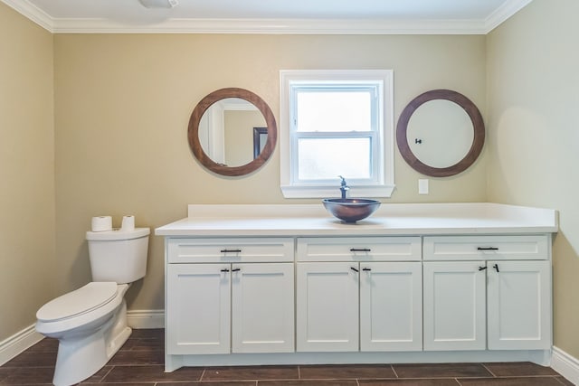 bathroom with ornamental molding, vanity, hardwood / wood-style floors, and toilet