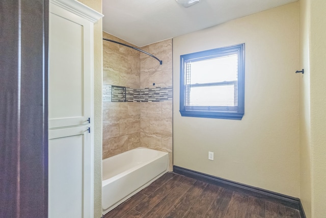 bathroom with wood-type flooring and tiled shower / bath combo