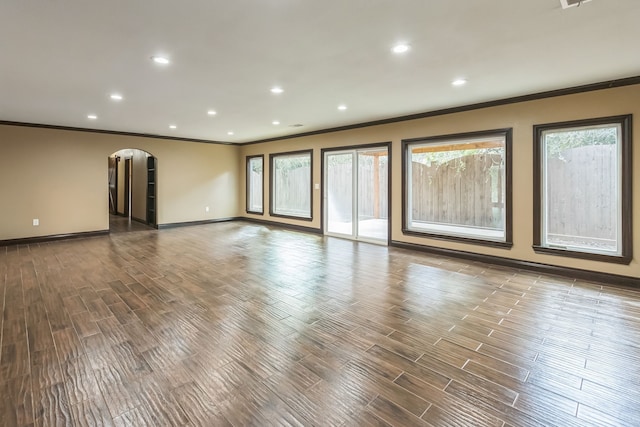 24578 Derry St, Hempstead, TX 77445 - unfurnished room with ornamental molding, arched walkways, wood finished floors, baseboards, and recessed lighting