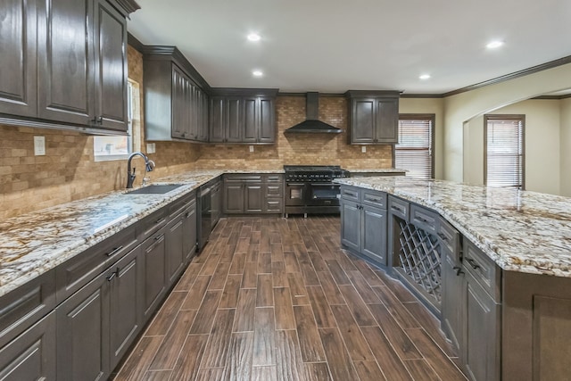 kitchen with dark hardwood / wood-style floors, sink, wall chimney range hood, stainless steel range, and dishwasher