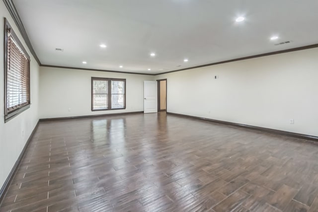 spare room featuring ornamental molding and dark wood-type flooring